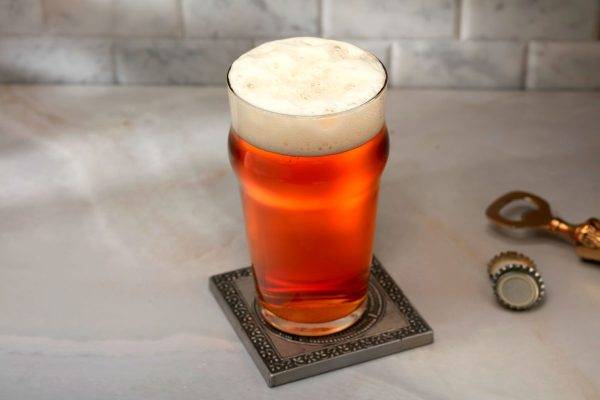 gold copper colored beer in pint glass